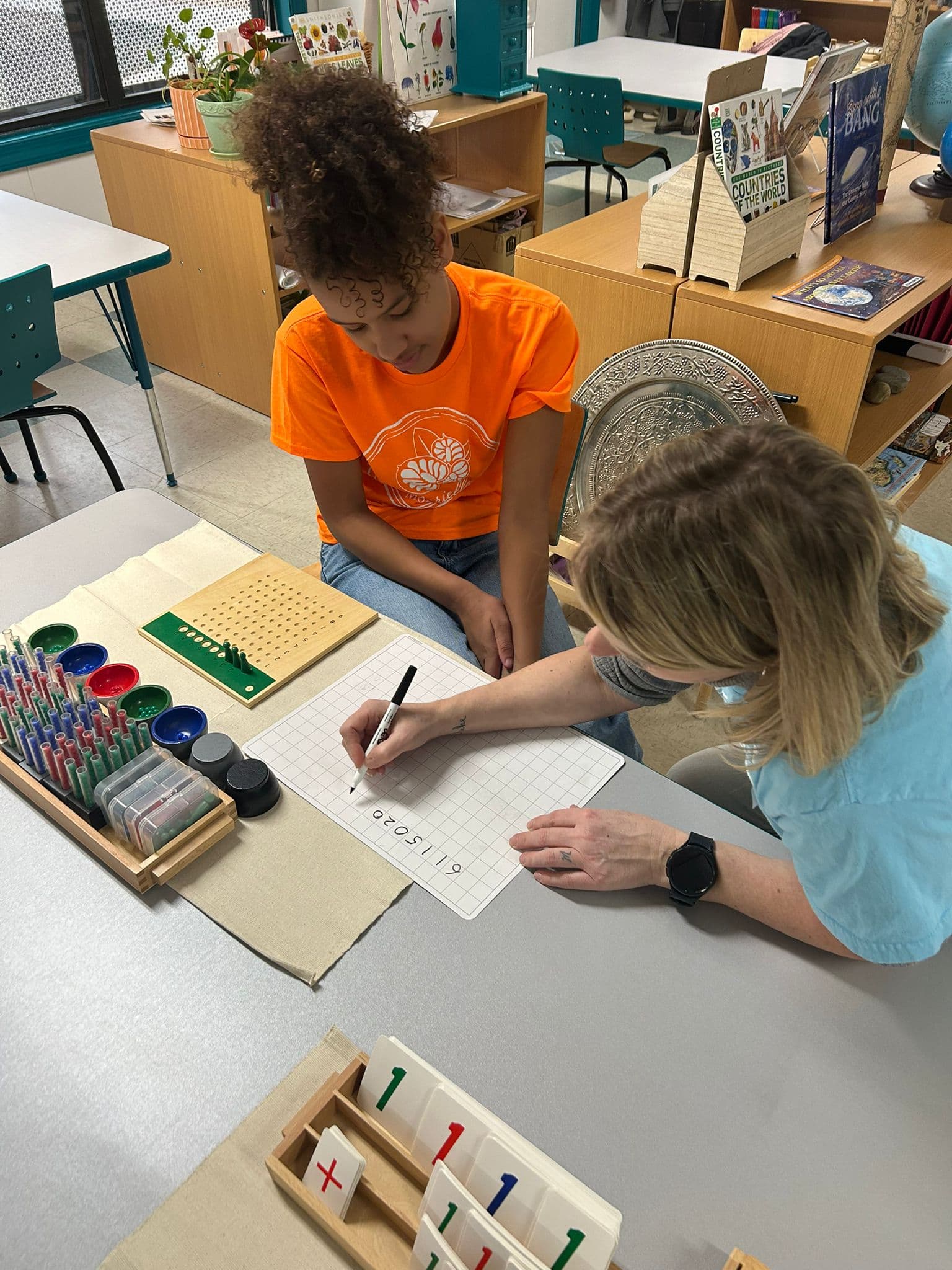 Teacher guiding a student through math concepts